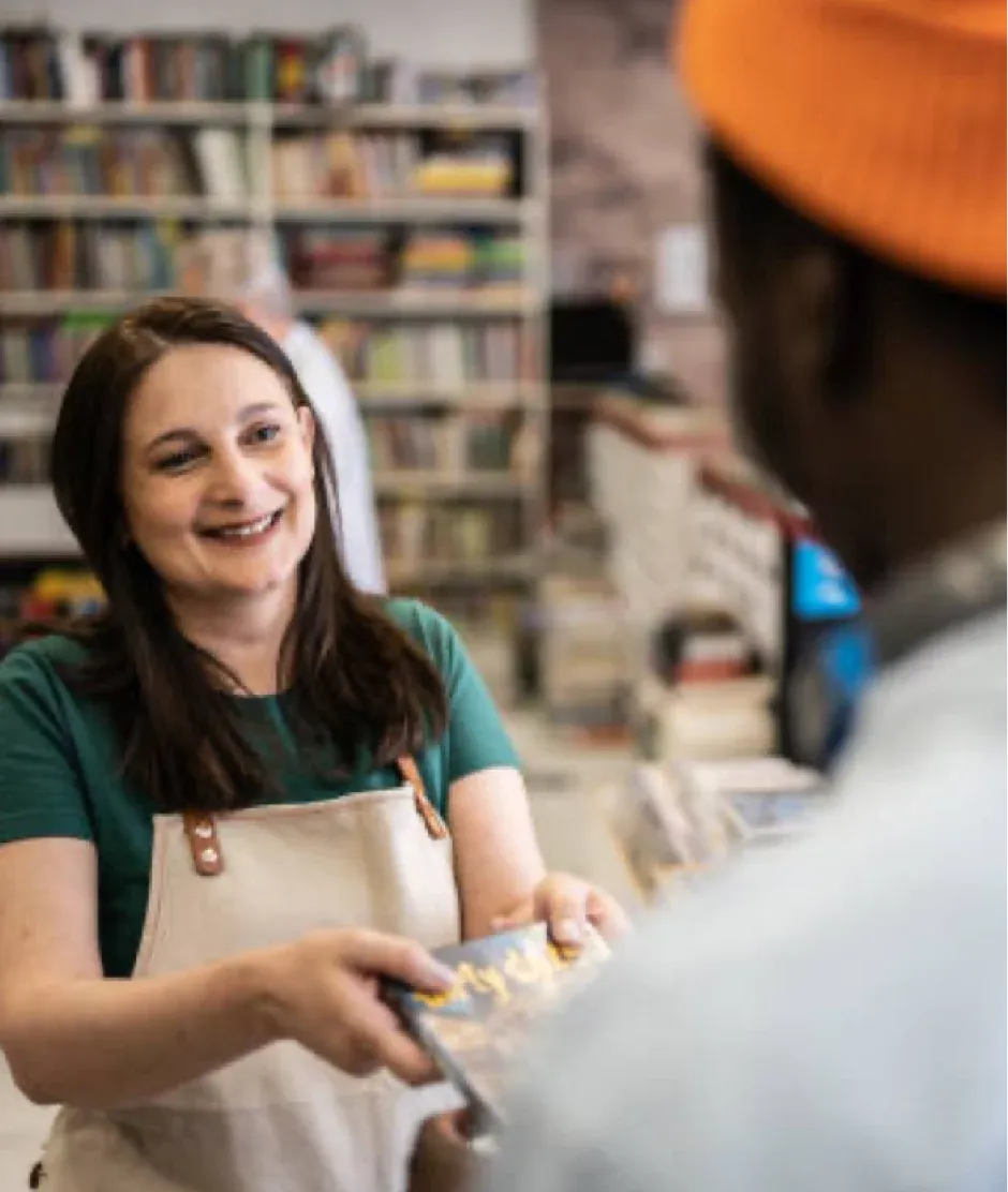 woman helping someone in shop