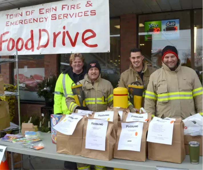 group of fire and emergency services people at food drive